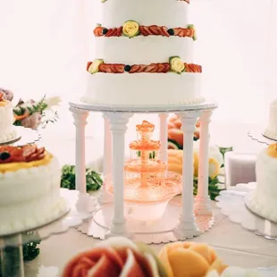 Pasteles Cisne delivered, set up, and provided all of the cake stands and waterfall. We were very happy w/ how it turned out!