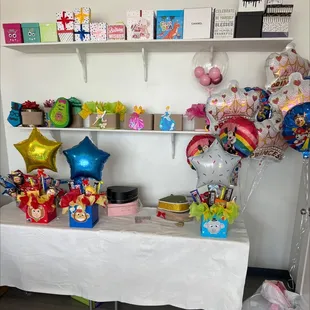 a table with balloons and gifts