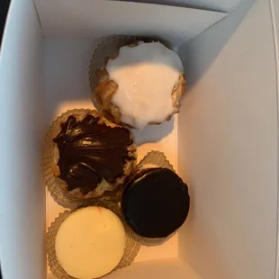 Chocolate cheesecake, New York cheesecake, vanilla cream puff and chocolate cream puff.