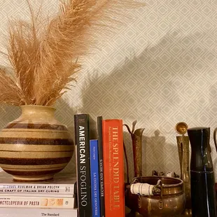 a vase and books on a shelf