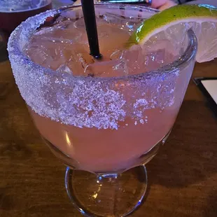 Strawberry margaritas on the rocks with a sugar rim