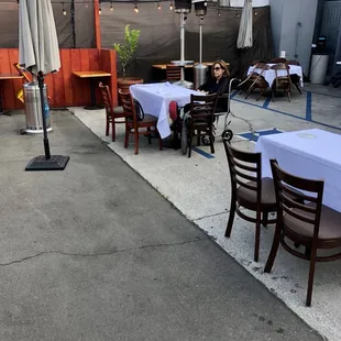 Outdoor seating in a converted parking area behind the restaurant