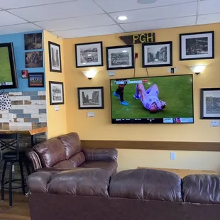 a living room with couches and a flat screen tv