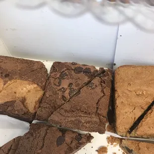 a variety of brownies in a display case