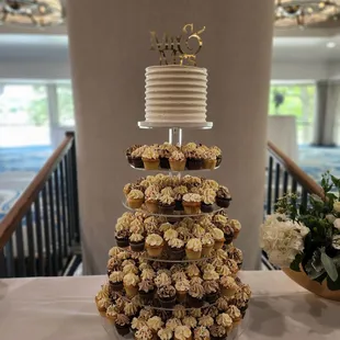 a wedding cake and cupcakes