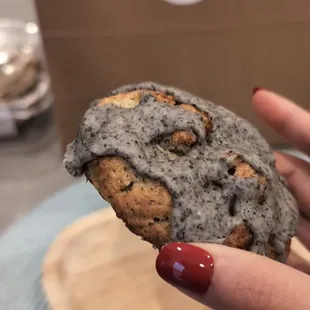 a hand holding a chocolate chip cookie