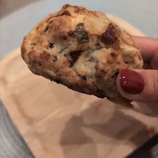 a hand holding a piece of bread