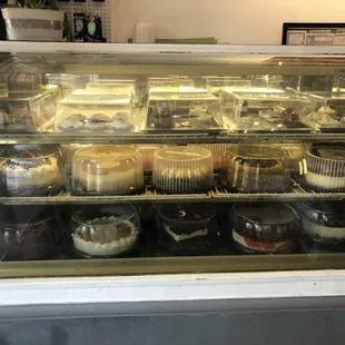 a display case filled with cakes and pastries