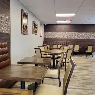 a dining area with tables and chairs