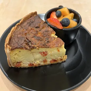 Tomato basil quiche with a side of fresh fruit.  Huge and delicious!