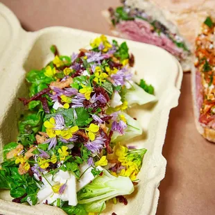 a salad in a styrofoam container