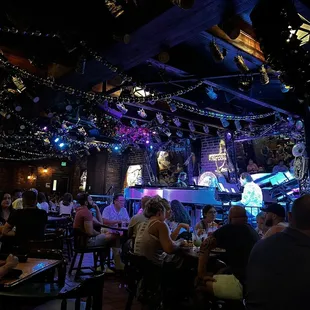 people sitting at tables in a restaurant