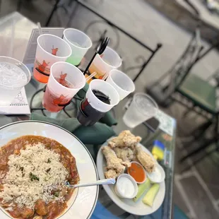 a plate of food and cups