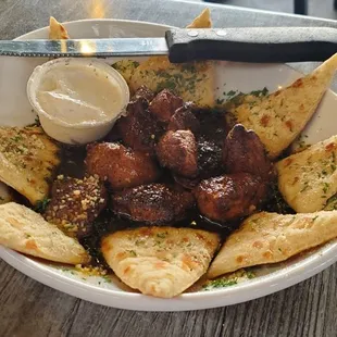 Cajun steak bites with pita chips and horsey sauce $13.99