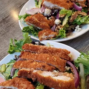 Walnut crusted chicken salad with blue cheese, walnuts, dried cherries Raspberry dressing, split into 2 plates $13.99
