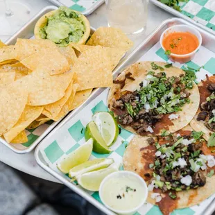 a tray of tacos and chips