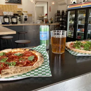 two pizzas and a beer