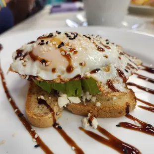 a fried egg on a toasted piece of bread