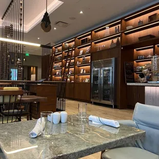 a restaurant with a marble table and chairs