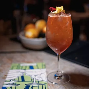 a glass of fruity drink on a table