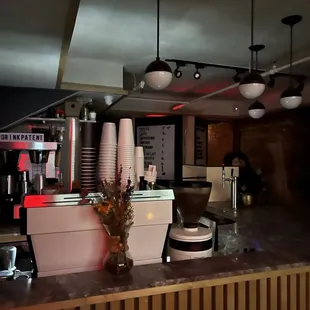 inside coffee shop, hidden door in back behind the coffee menu wall