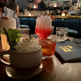 a man sitting at a table with drinks