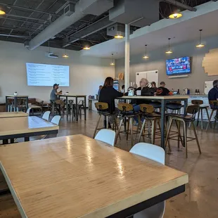 people sitting at tables in a large room