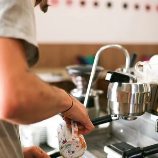 a bari serving a cup of coffee