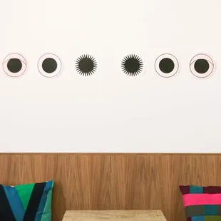 a row of tables with colorful cushions