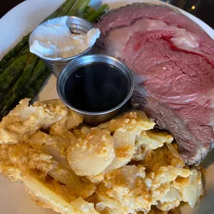 Medium rare prime rib with au gratin, potatoes and asparagus.