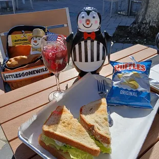 Chicken Salad w lettuce on toasted white bread and a bag of chips