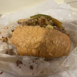 a half eaten sandwich in a wrapper