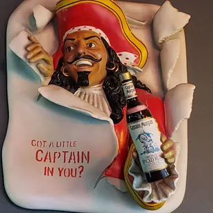 captain in bed with bottle of beer