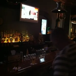 a man sitting at a bar watching television