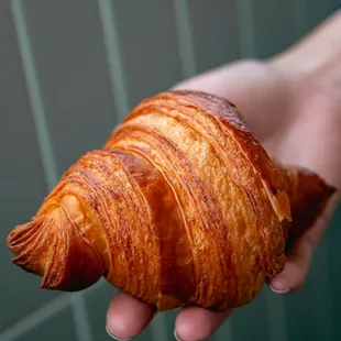 flaky layers of a butter croissant