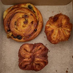 Escargot Pain aux Raisins (top left), Classic Kouignette (top right), and Cardamom Kouignette