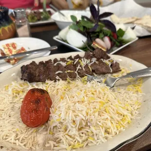 a plate of food with meat and rice