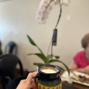 a person holding a cup of coffee