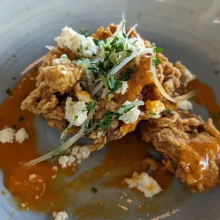 Couldn&apos;t wait to take a bite of buffalo fired oysters before snapping a pic.