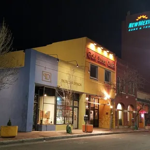 By night, PATRICIAN DESIGN&apos;S STUDIO AND BOUTIQUE GALLERY OF ART AND GIFTS glows on Gold Avenue - downtown.