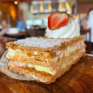 a piece of cake with a strawberry on top