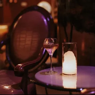 a glass of wine and a candle