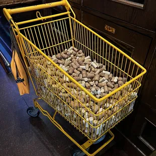 a shopping cart full of wine corks