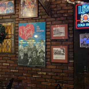 a brick wall with posters on it