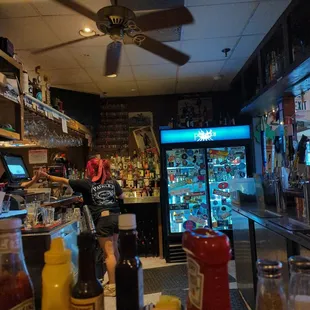 a bar with a ceiling fan
