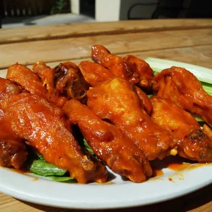 a plate of wings and celery