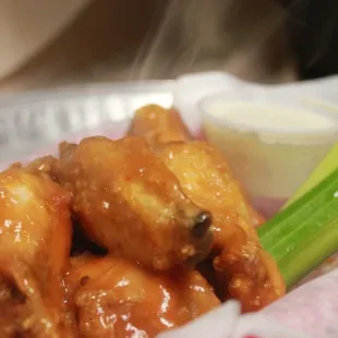 a plate of chicken wings and celery