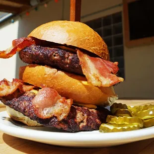 a burger with bacon and pickles