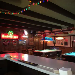 a pool table and neon signs
