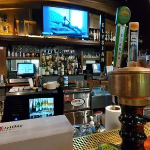 a bar with a television and a television